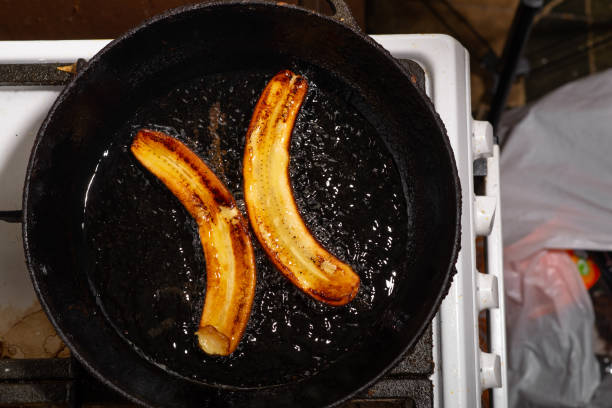 Fried bananas in a pan. Raw bananas boiled in oil.