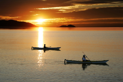 father and son kayaking on serene lake at sunset (XL)