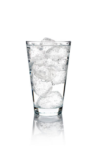 Glass of mineral carbonated water with ice cubes Glass of mineral carbonated water with ice cubes. isolated on white background tonic water stock pictures, royalty-free photos & images