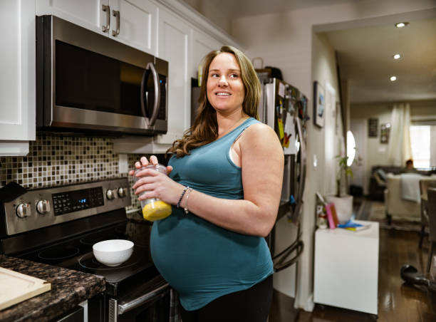 istock Expecting mother having a snack at home 1369178314