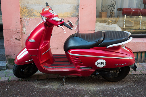 Colmar - France - 5 February 2022 - Profile view of red Peugeot django scooterparked in the street