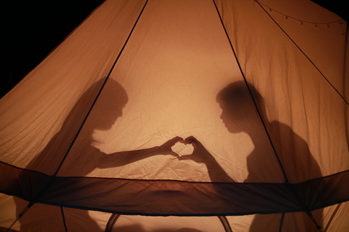 Camping romance ,Shadow of a couple in love in a tourist tent in nature. camping in the wilderness, love valentine concept