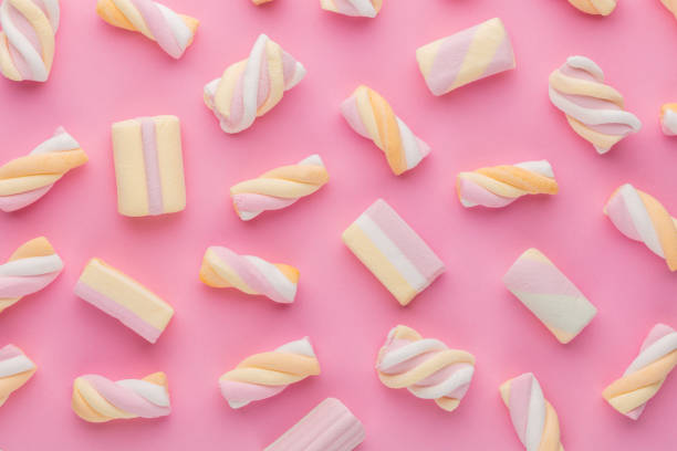 istock Colorful marshmallows on pastel background. 1369179399