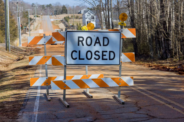 istock A bright orange road closed ahead sign caution cones barricades are blocking 1369179469