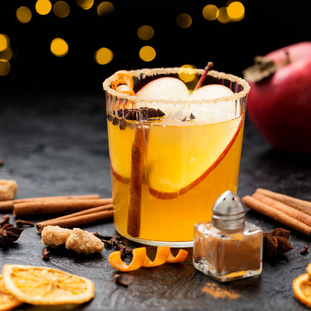 istock Hard apple cider spiced cocktail with sliced red apples 1369179701