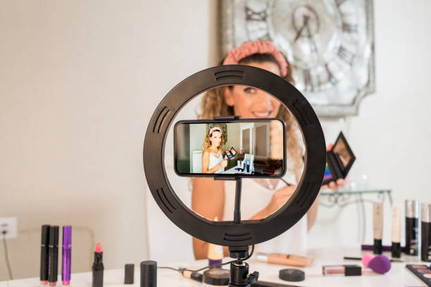 istock Young woman vlogger recording a make-up video for her vlog 1369179802