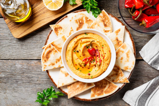 istock Roasted red pepper hummus with pita bread 1369180686