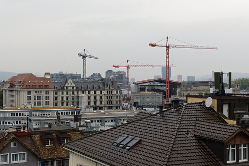 09.15.2021 zurich city main station: many construction cranes at the central and main station, there is a lot of construction and new buildings are created, environmental problems and lack of space are the result, cloudy day, without people