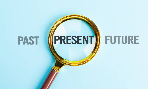 Present wording inside of Magnifier glass on blue background for focus current situation , positive thinking mindset concept. Present wording inside of Magnifier glass on blue background for focus current situation , positive thinking mindset concept changing focus stock pictures, royalty-free photos & images