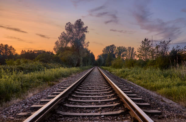istock Railroad tracks and beautiful sky at sunset 1369182143