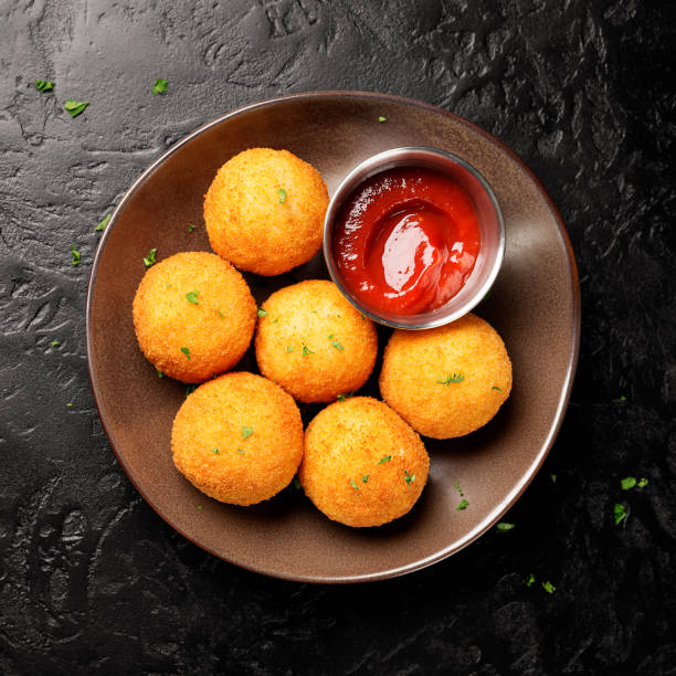 istock Homemade Fried Risotto Arancini stuffed with mushroom and parmesan 1369183295