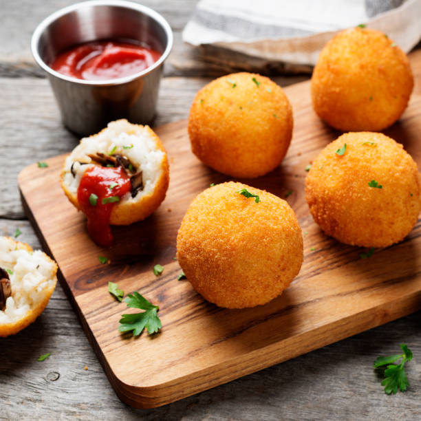 Homemade Fried Risotto Arancini stuffed with mushroom and parmesan