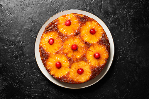 Homemade pineapple upside down pie with candied cranberry . Tropical dessert .	Top view