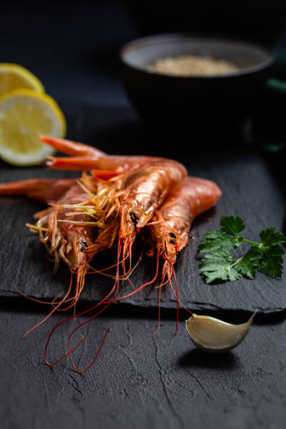 a bunch of prawns on slate table