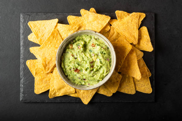 istock Mexican nachos chips and guacomole sauce 1369185022