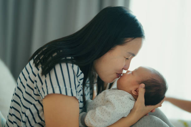 istock Single mother with two chrildren relaxing in bedroom 1369185783