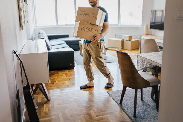 istock Males volunteer holding a cardboard box for donation 1369185803