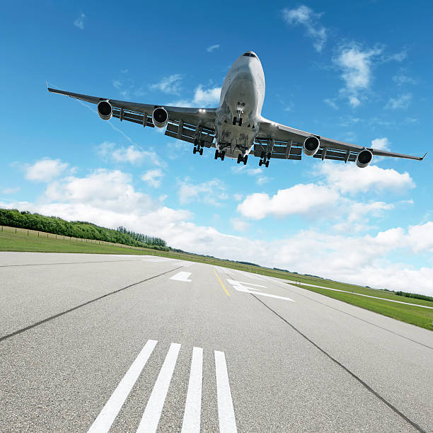istock XL jumbo jet airplane landing on runway 136918791