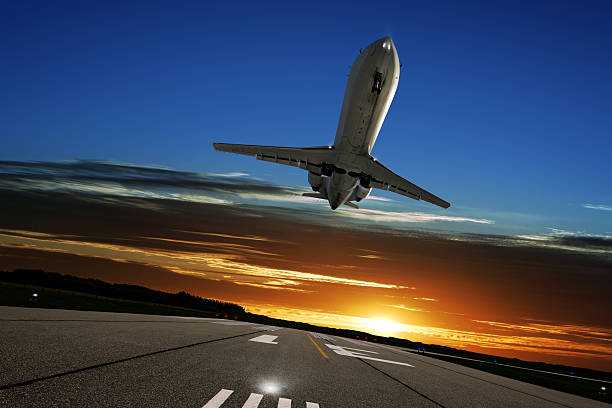 istock XL corporate jet airplane landing at sunset 136918811