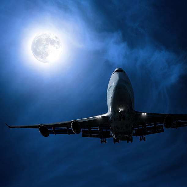 istock jumbo jet airplane landing at night 136918812