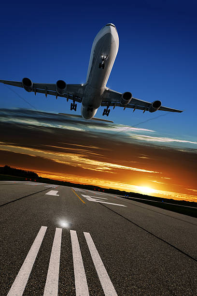istock XL jet airplane landing at sunset 136918819