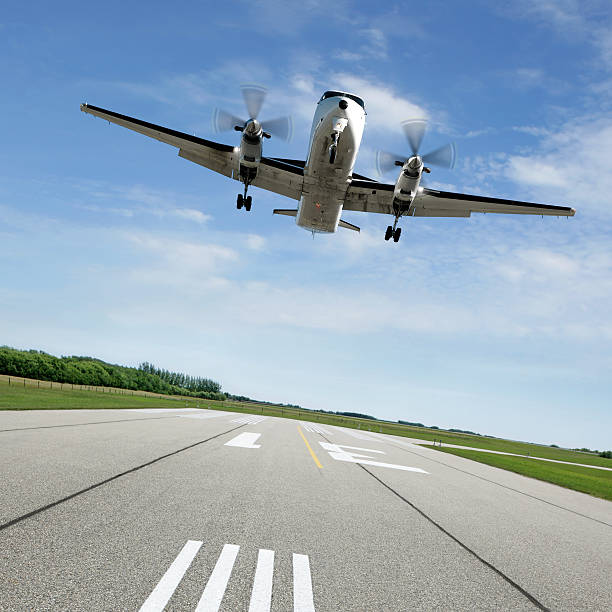 XL propeller airplane landing on runway stock photo