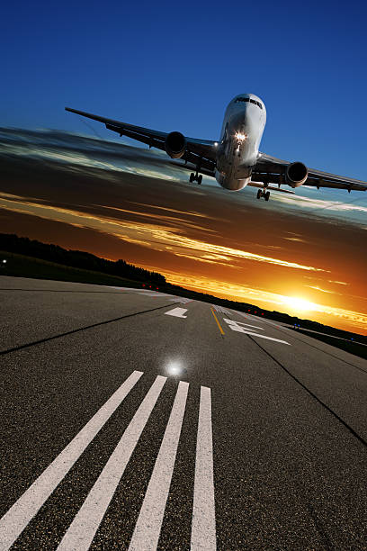 istock XL jet airplane landing at sunset 136918822