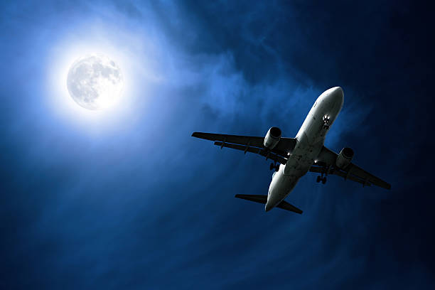 istock jet airplane landing at night 136918836