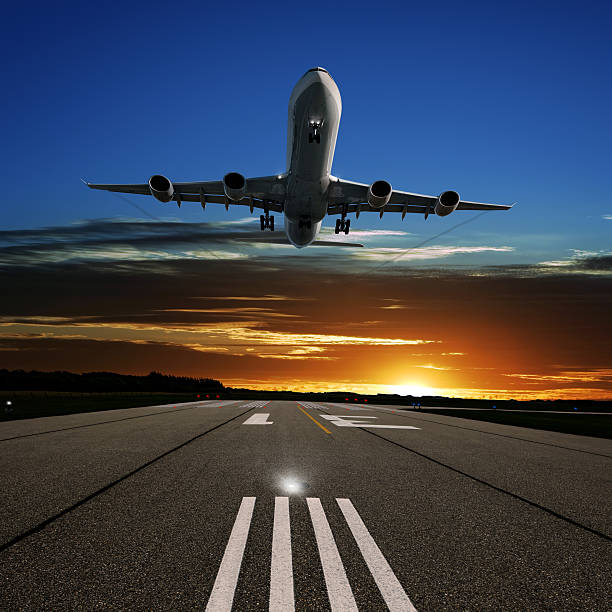 istock XL jet airplane landing at sunset 136918852