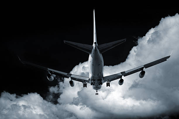 istock XL jumbo jet airplane landing at night 136918899