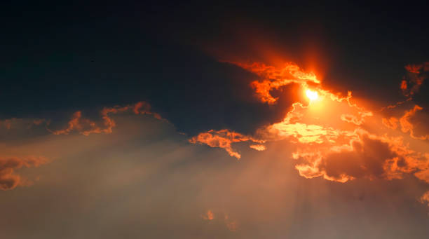istock Sunlight Sun Rays Shining Through Clouds in Sky Symbolizing Hope 1369189215