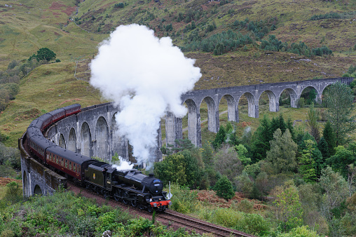 Glenfinnan, Scotland, UK - 04 October, 2019, The Jacobite Steam Train and Glenfinnan viaduct in Scotland Highland, UK