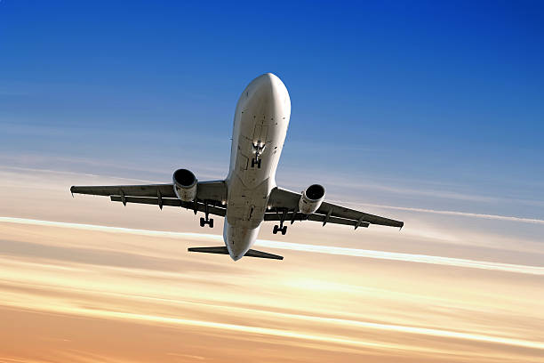 istock XL jet airplane landing at sunset 136918976