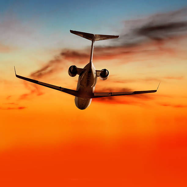 istock XL corporate jet airplane flying at sunset 136918980