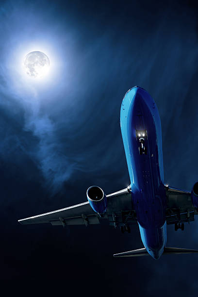 istock jet airplane landing at night 136918998