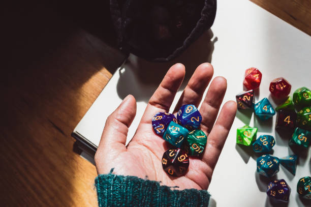 A hand holding various-shaped RPG dice stock photo