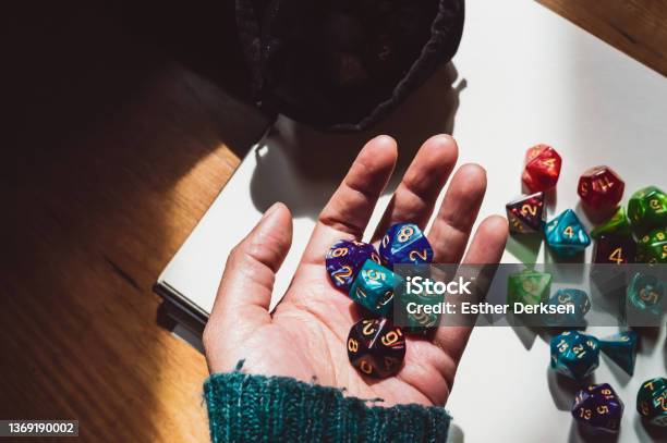 A Hand Holding Variousshaped Rpg Dice Stock Photo - Download Image Now - Board Game, Dragon, Dungeon