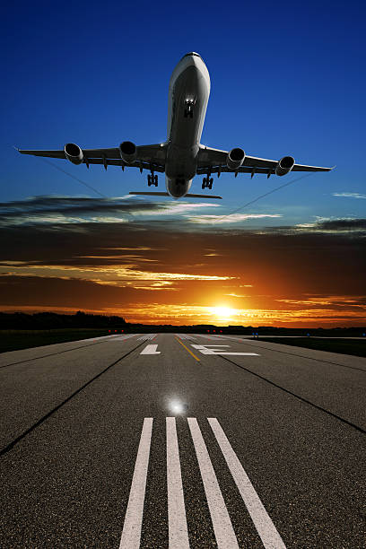 istock XL jet airplane landing at sunset 136919027
