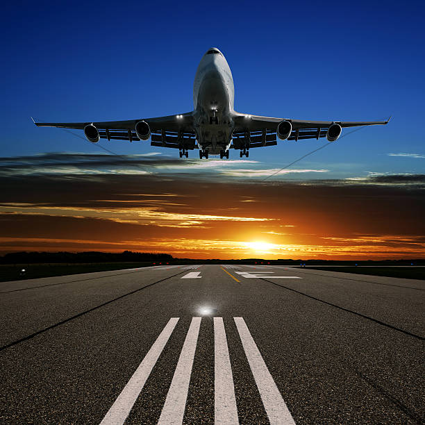 XL jumbo jet airplane landing at sunset