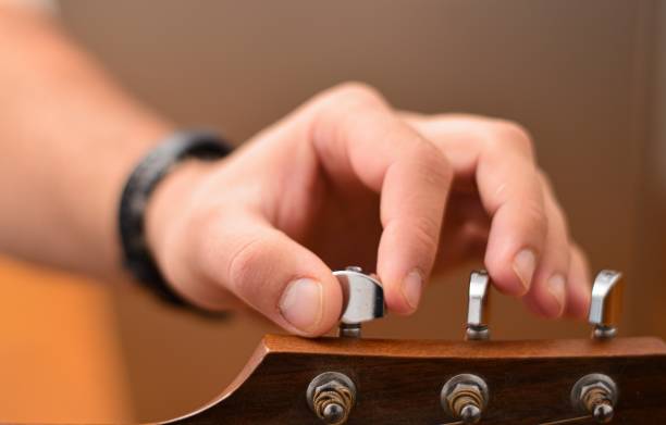 istock Mid age man taking an online course for guitar 1369191268
