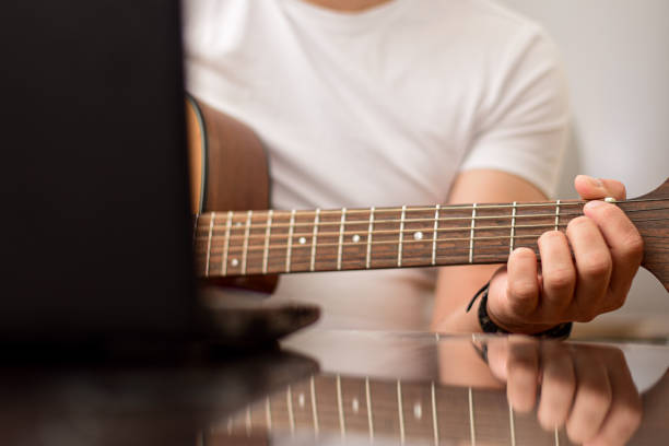 istock Mid age man taking an online course for guitar 1369191472
