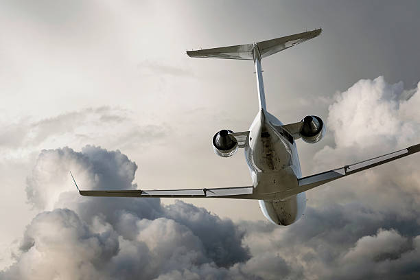 istock corporate jet airplane flying in storm 136919151