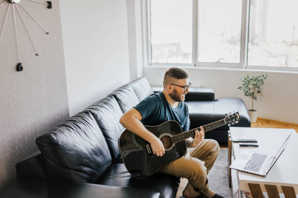 istock Acoustic guitar teaching through a video callteaching, 1369191543