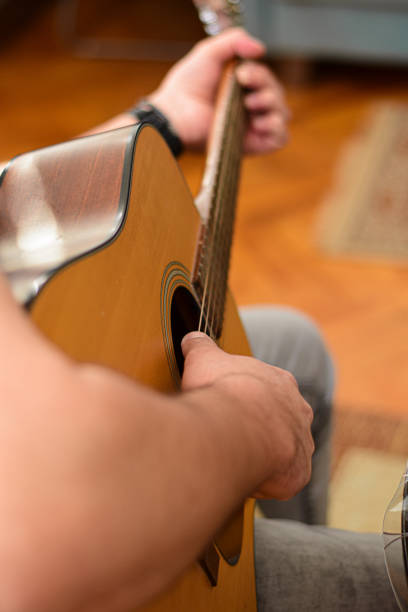 istock Mid age man taking an online course for guitar 1369191566