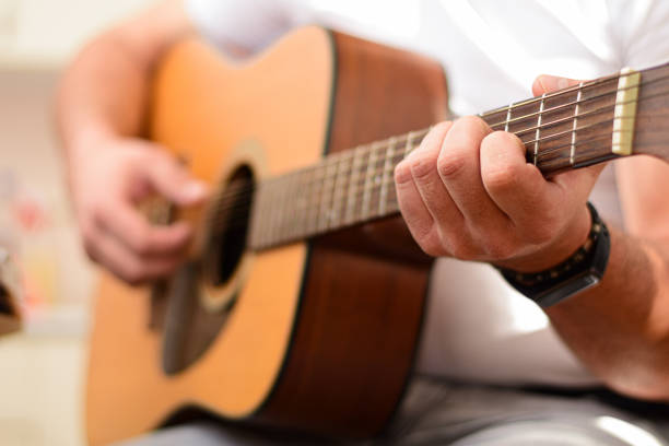 istock Mid age man taking an online course for guitar 1369191578