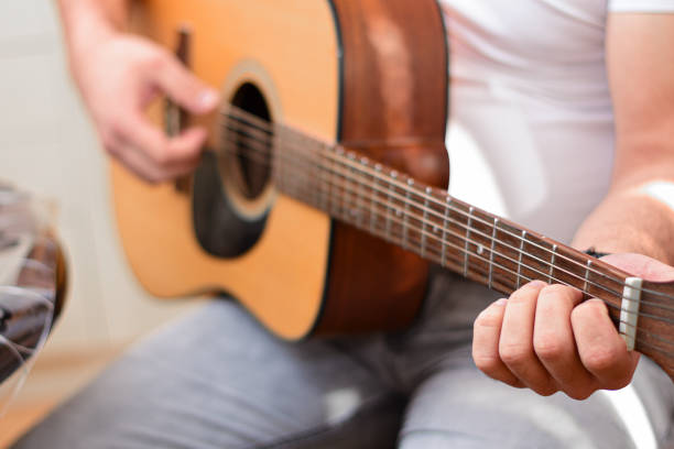 istock Mid age man taking an online course for guitar 1369191723
