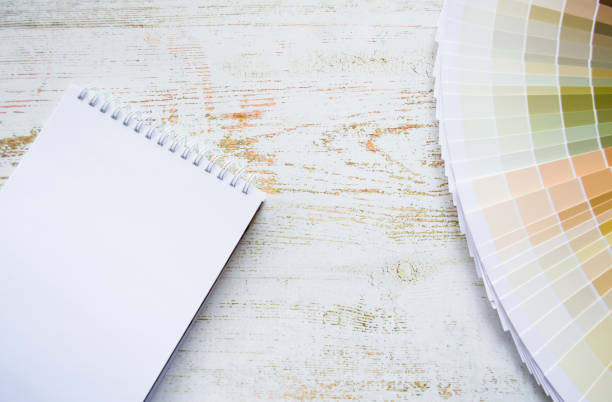 istock Fan paint samples interior design painting natural Colors. Wooden background, notebook, copy space 1369191729
