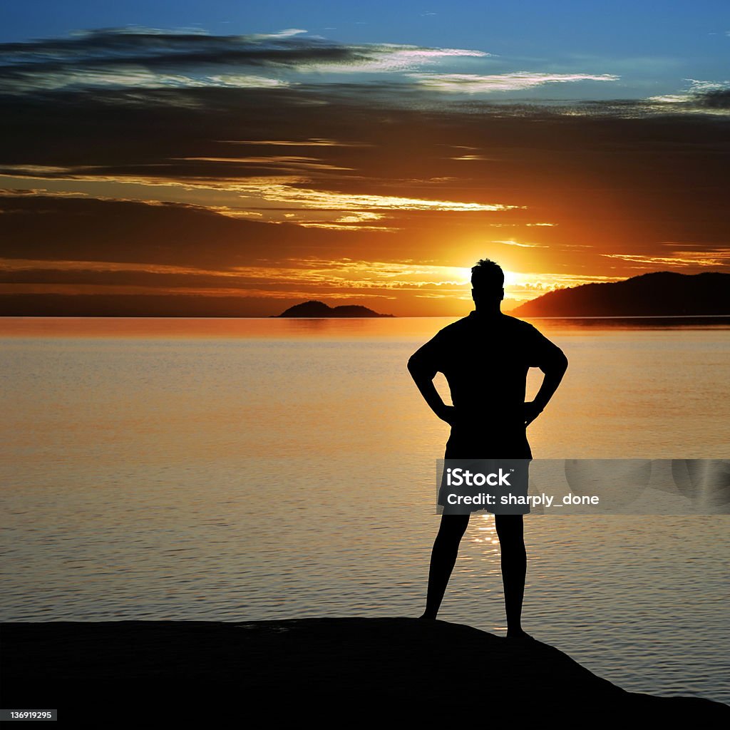 XL serene man sunset serene man in sihouette overlooking lake at sunset, square frame (XL) Achievement Stock Photo