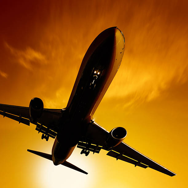 istock XL jet airplane landing at sunset 136919296