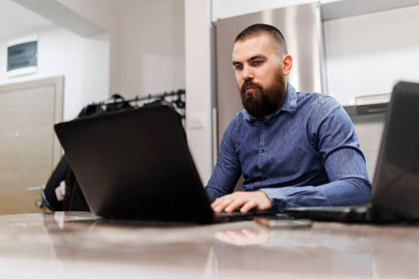 istock Exhausted young businessman working at home office 1369193741